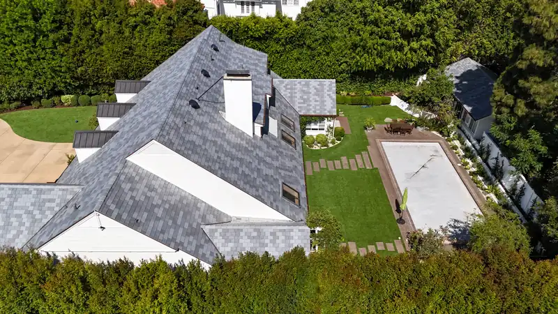 Aerial view of a large house roofed in DaVinci composite slate-look tile in blended grays